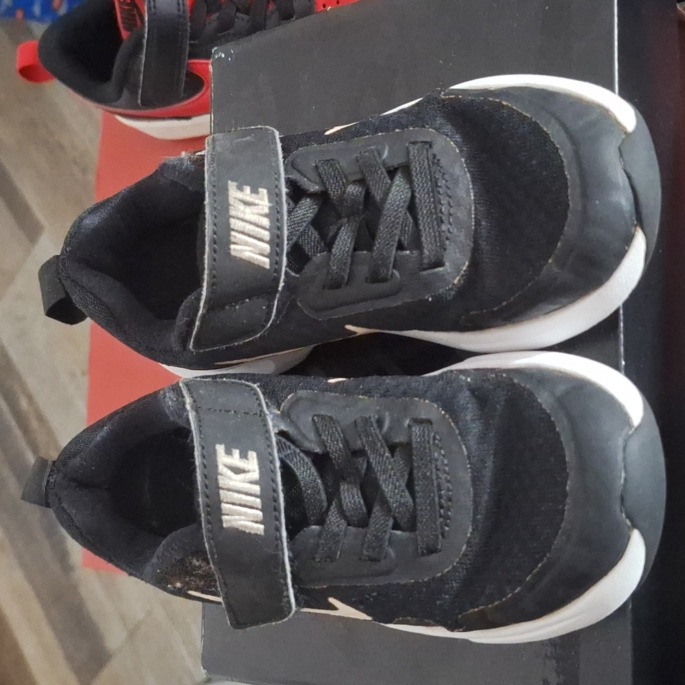 Used boys Nike shoes black with white stripe.